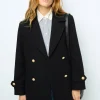 Shop Flared jeans with monogram - ANNA Coats