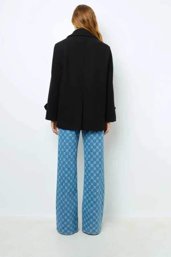 Shop Flared jeans with monogram - ANNA Coats